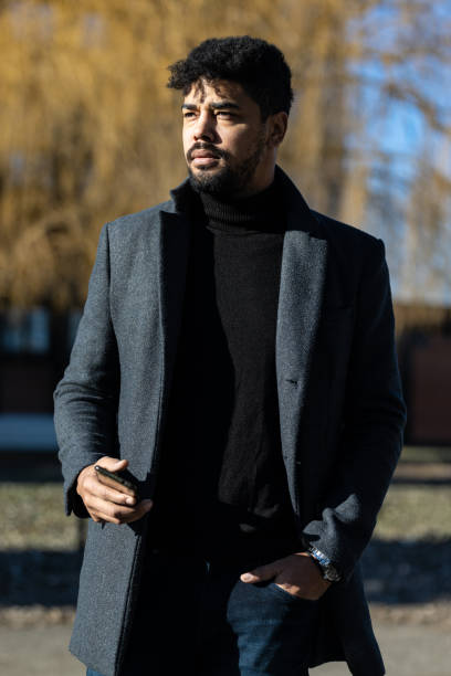 istock Confident businessman with mobile phone 1365852423