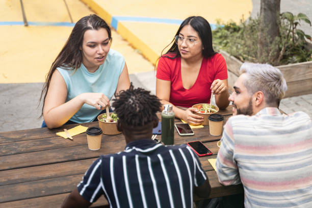 istock Young friends eating take out food and working together during work break 1365854241
