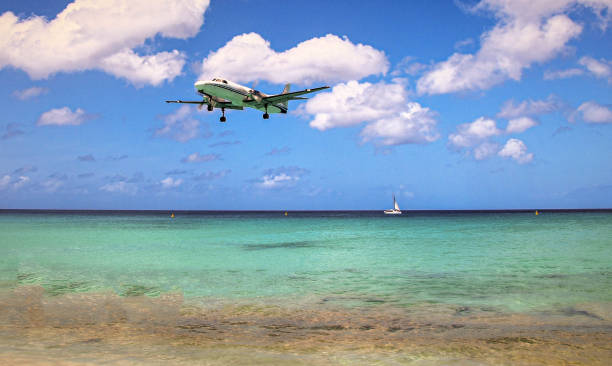 istock Plane landing on a white Caribbean sand beach 1365855198