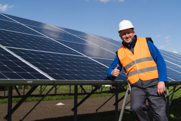 istock Satisfied worker showing thumb up gesture while standing near solar panels at power plant 1365858200