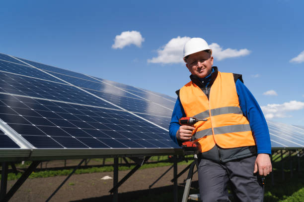 istock Portrait of a solar panel station worker with a drill screwdriver in his hand 1365858272