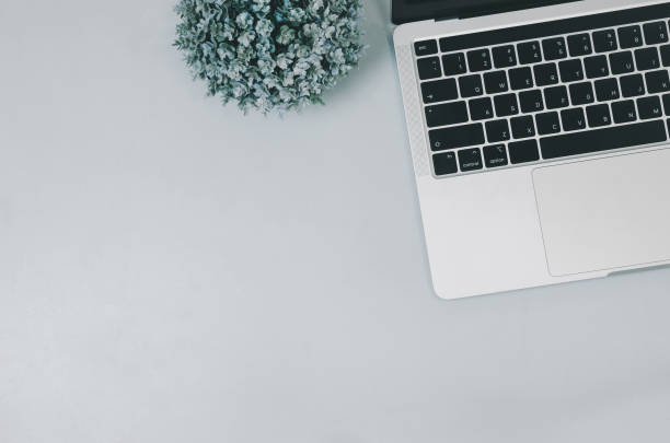 istock Top view flat lay computer laptop and flower on table.Copy space 1365858488