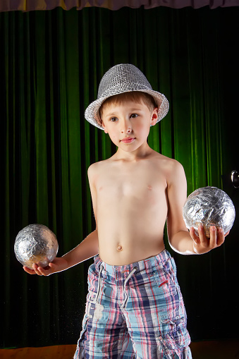 Little boy learns to juggle. Child of the circus.