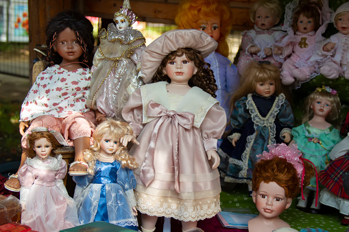 Vintage dolls on the market showcase. Antique toys are on sale.