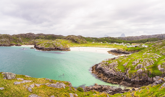 Beautiful sandy beaches in Achmelvich Bay surrounded by rugged countryside in the Scottish Highlands.