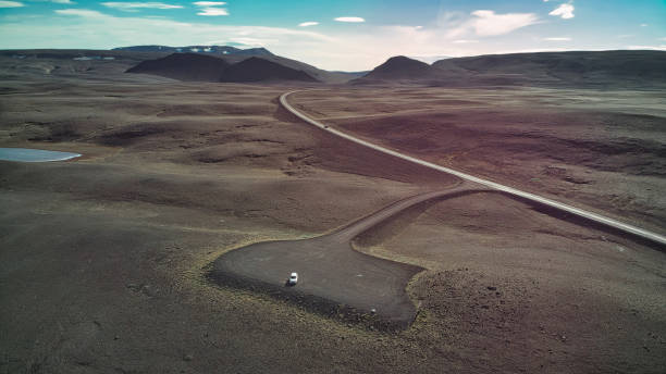 drone flight over lonely road in the iclandic highlands - hofmann imagens e fotografias de stock