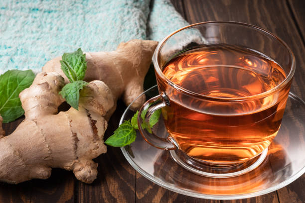 istock Ginger tea mint leaves and ginger roots 1365864762