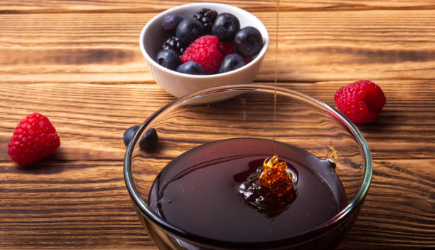 Honey pouring with some berries