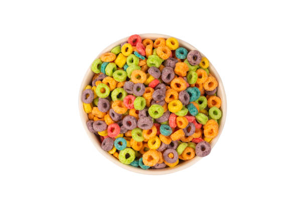 Colorful rings cereal spill out into a bowl. Breakfast. Isolated.
