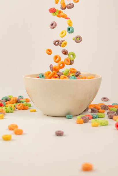 istock Colorful cereal box for morning breakfast. Corn flakes falling to the white bowl. Motion. 1365865054