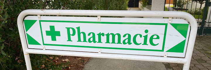 Pharmacy French sign with a green cross at the entrance of a drugstore
