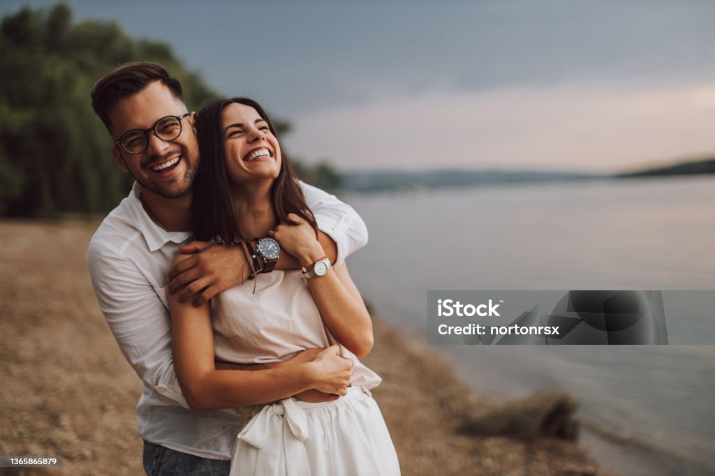 Happy face at the beach. Two lovers in a hug, in love. Couple - Relationship Stock Photo