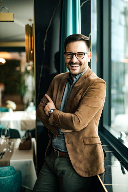 Portrait of a successful business owner standing near the window in the restaurant. stock photo