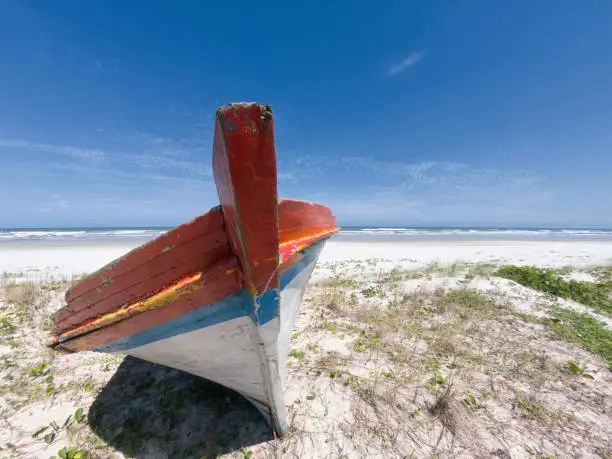 Remains of the hull of a wrecked trawler on a beach in southern Brazil