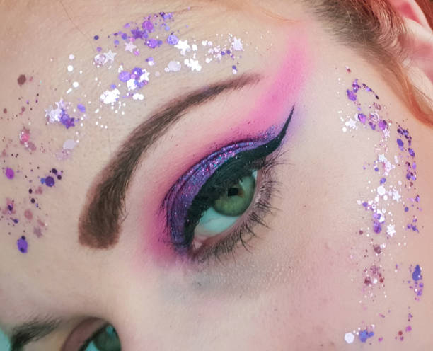 istock Colorful creative purple and shiny make up on my face 1365868312