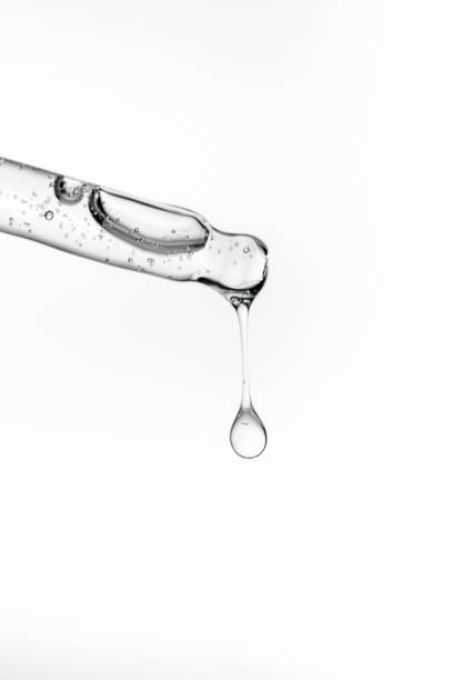 istock Transparent pipette with cosmetics on a white isolated background. 1365868904