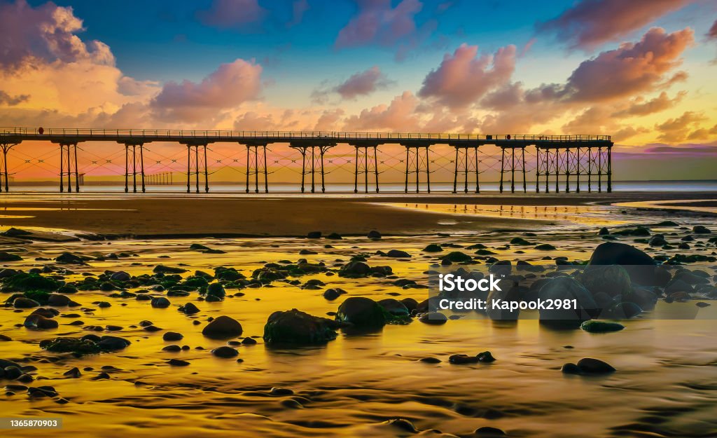 The Pier at Sunset on the coast of Saltburn with rocks in foreground Awe Stock Photo