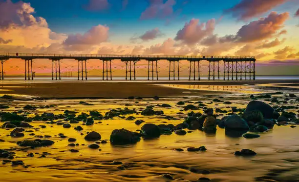 The Pier at Sunset on the coast of Saltburn with rocks in foreground