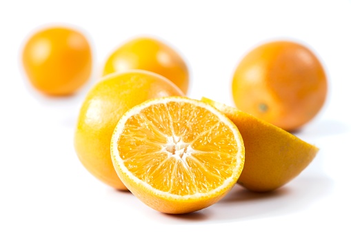 Group of half, peeled and whole tangerines on the stone background, still life concepts