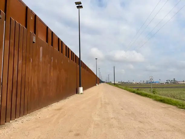 Photo of US-Mexico border. Border wall.Walls and security roads.