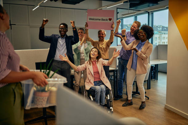 istock Colleagues greet a man who came from sick leave 1365873196
