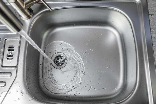 istock Water flows from a faucet into a sink 1365874359