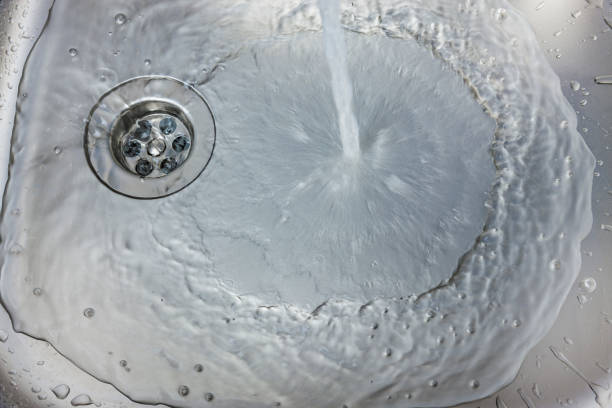 istock Water flows from a faucet into a sink 1365874393