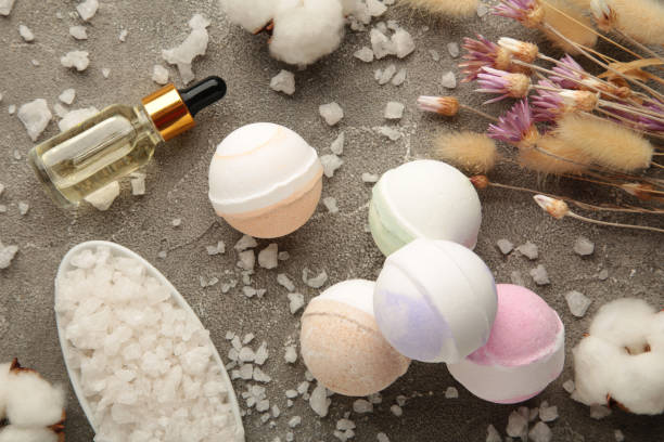 istock Composition with bath bombs, sea salt, dry flowers on grey background. 1365874534