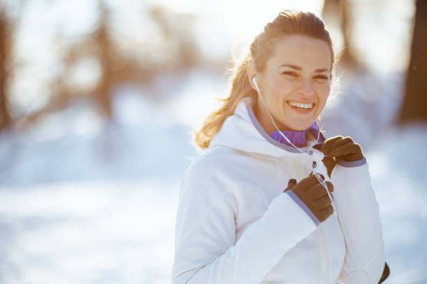 istock Portrait of smiling active woman in white jacket 1365875742