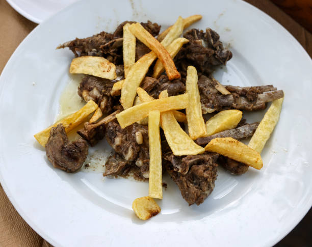 istock grilled goat with fries on a white plate 1365875780