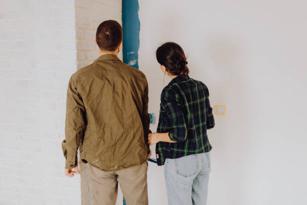 istock Young couple doing on hers apartment repair together themselves 1365876084