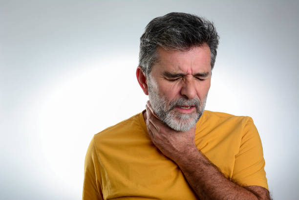 istock Mature bearded man having sore throat and touching his neck 1365876086