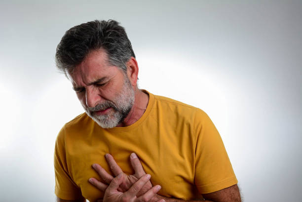 istock Man suffering from chest pain with painful expression. 1365876090