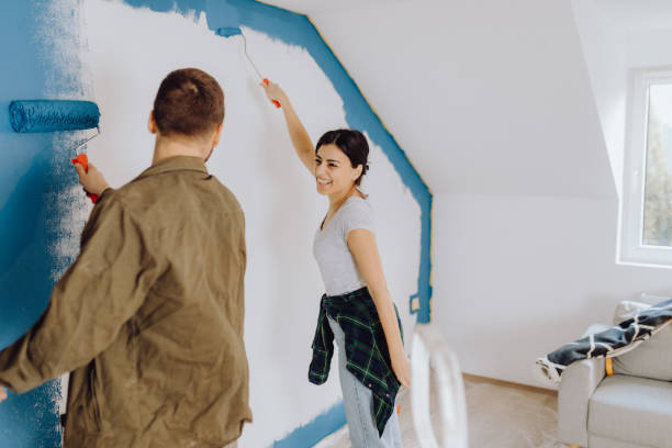 istock Young couple doing on hers apartment repair together themselves 1365876253
