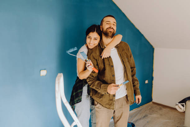istock Young couple doing on hers apartment repair together themselves 1365876466