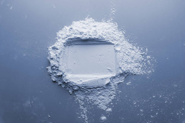 Powder with dent from card om blue background stock photo