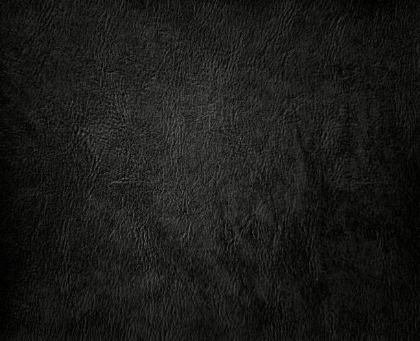 dark black faux leather. dark grey artificial leather background for luxury and elegant concept. plain background of elegant black leather in close-up view.