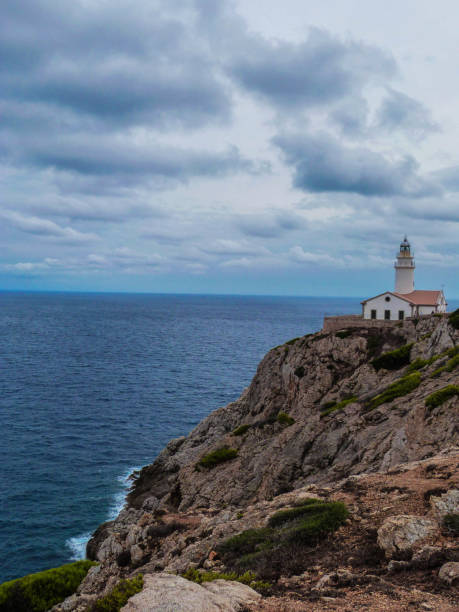 istock lighthouse on a rock with cloudy sky and mediterranean sea 1365878591