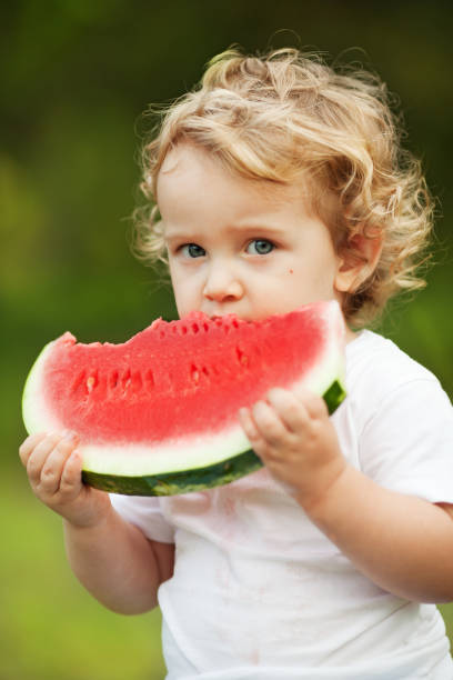 istock Child Eating Watermelon 1365879305