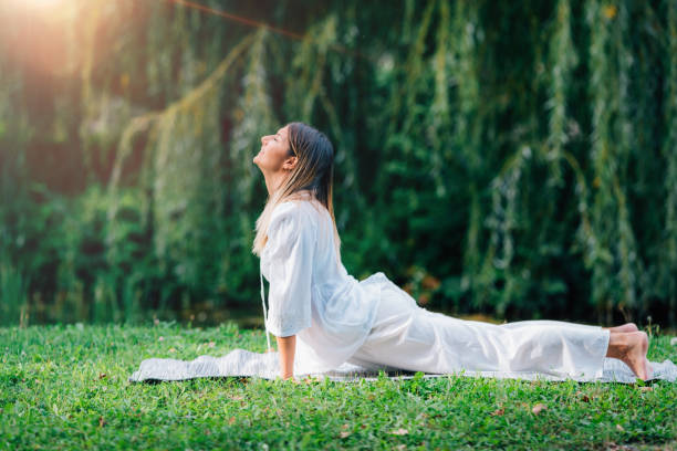 istock Yoga by the lake, cobra position 1365879556