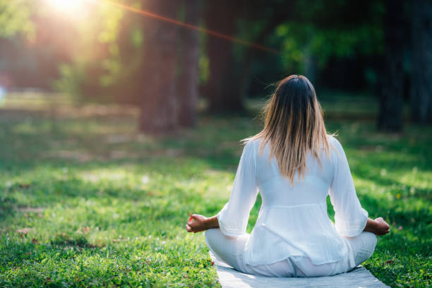 istock Meditating by the Water, Green Nature Background 1365879836