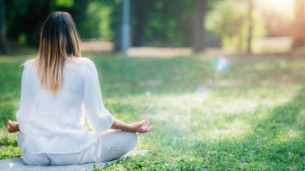 istock Meditating by the Water, Green Nature Background 1365879902