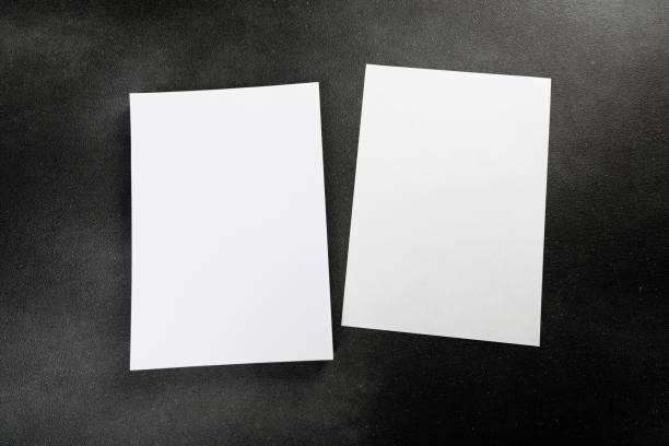 istock Blank flyer poster A4 paper isolated on dark gray to replace your design 1365880100