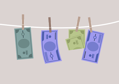 Banknote bills drying pinned on a clothesline, a money laundry concept