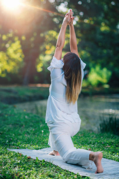 istock Yoga in Nature, Peaceful Warrior Pose. 1365880874