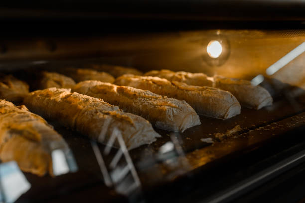 istock Close up bread baguette baking process in a bakery manufacturing. 1365881365
