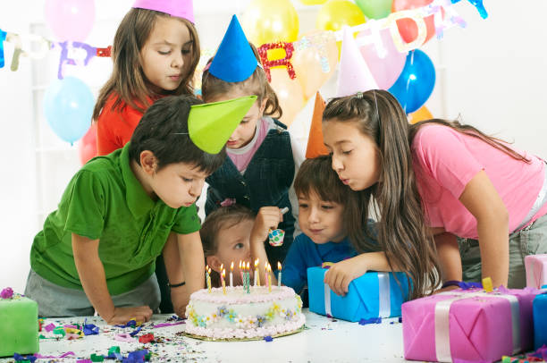 istock Children blowing Birthday candles 1365881693
