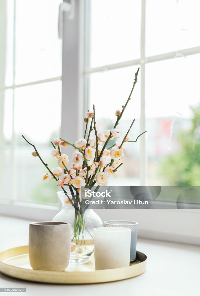 Vase with flowers and candles on the windowsill. Women's Day. Mother's Day. a beautiful romantic day. summer concept. Candle Stock Photo