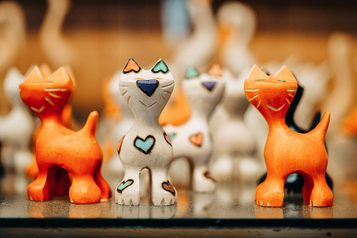 Hand of a child playing with figurines of wild animals and learning trough the game.