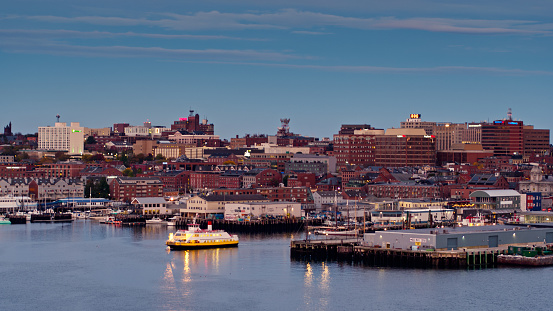 Aerial shot of Portland, Maine in just before sunrise, flying over Casco Bay and looking over the waterfront to the Old Port and Downtown. A ferry is pulling away from the dock.
   
Authorization was obtained from the FAA for this operation in restricted airspace.